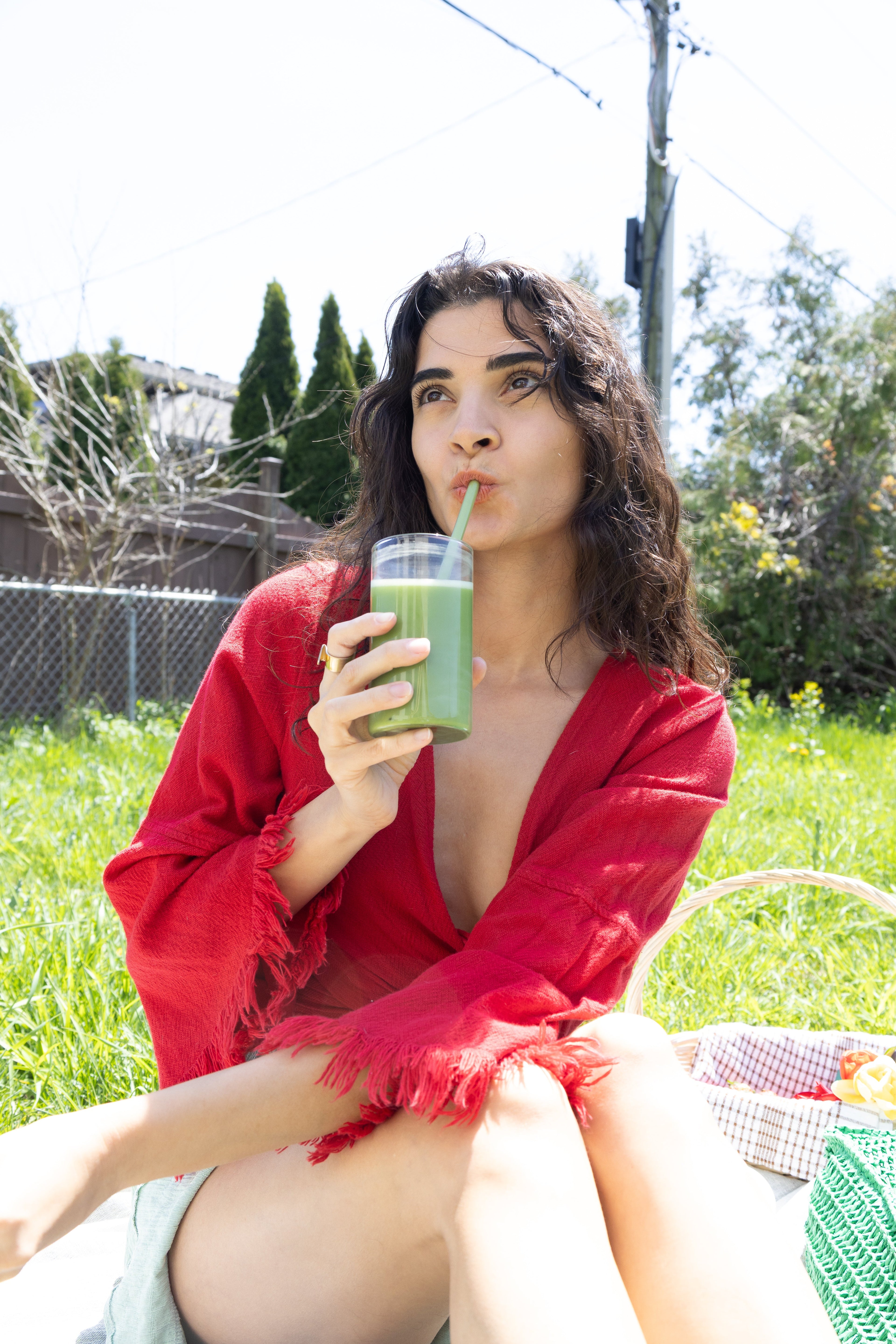 Woman holding Rain Dust Smooth & Creamy ceremonial grade Japanese matcha powder, showcasing its vibrant green colour and fine texture.