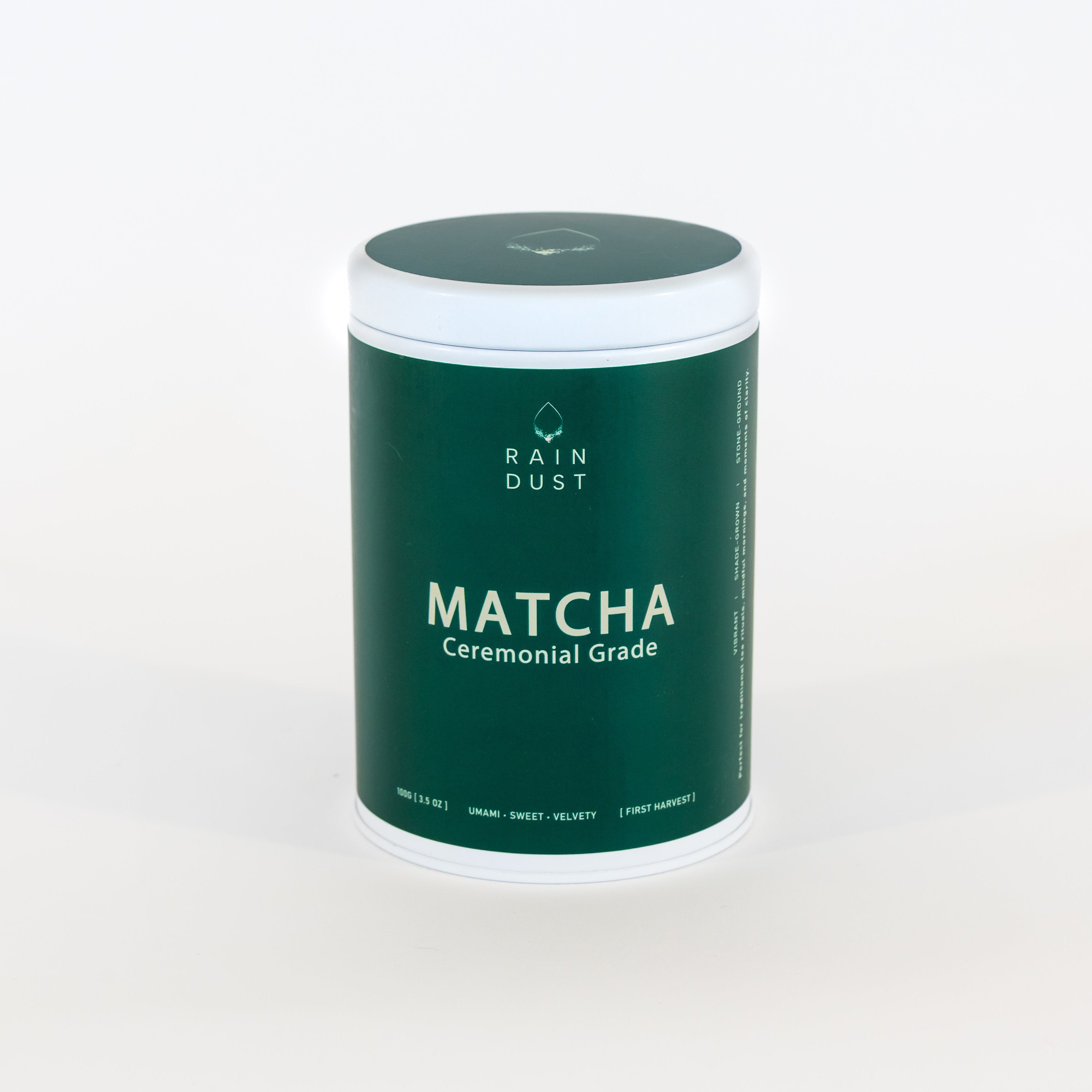 Green container of Rain Dust Matcha on a white background