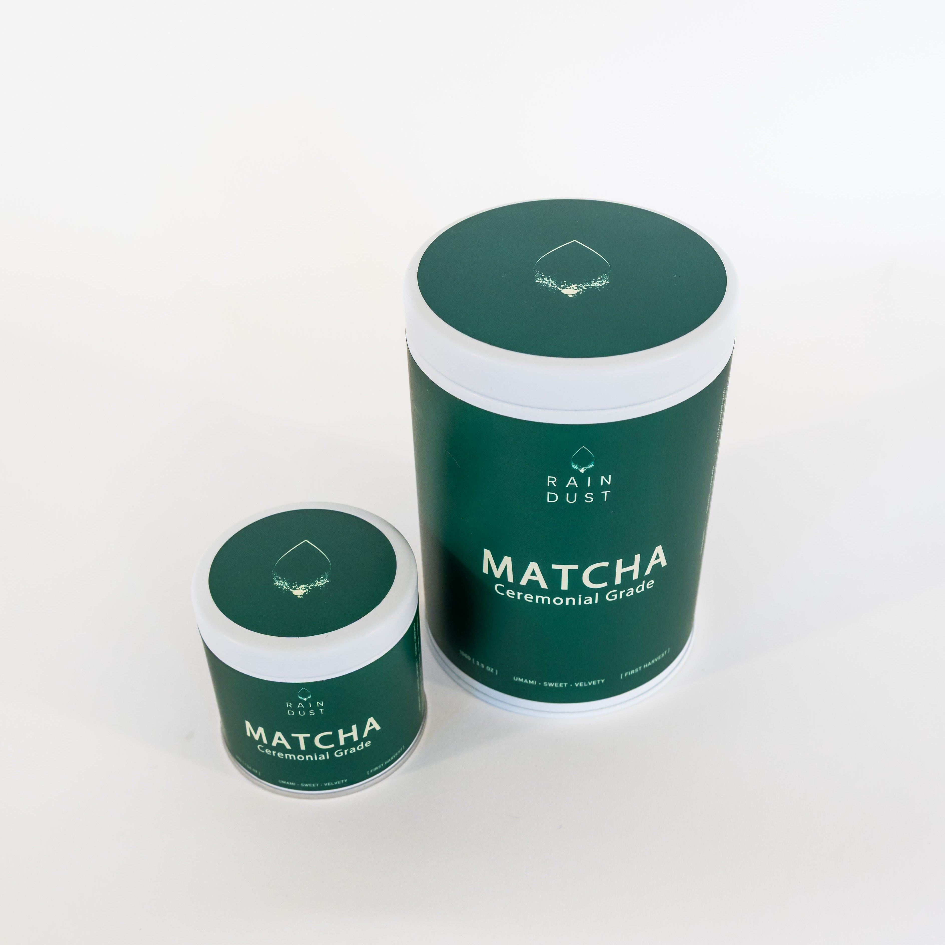 Two size green containers labeled 'Rain Dust Matcha' on a white background