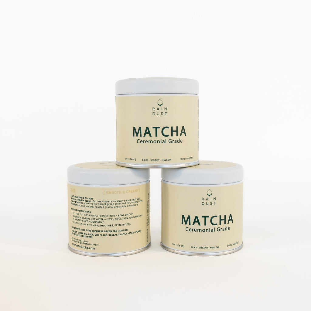 Three containers of  raindust ceremonial matcha green tea powder on a white background